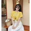 Ảnh của Áo phông vàng chữ lệch vai mix áo yếm